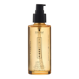 Schwarzkopf Fibreclinix hair oil in a gold bottle with a black pump on a white background