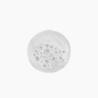 Pooled Kevin Murphy Young Again Wash shampoo, showcasing its silky, milky texture.