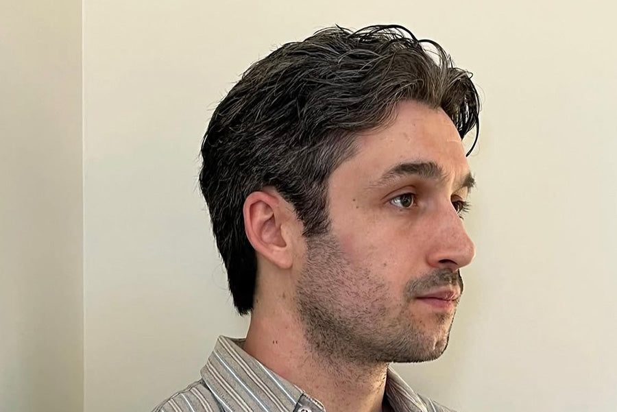 Man wearing a striped shirt against a plain background