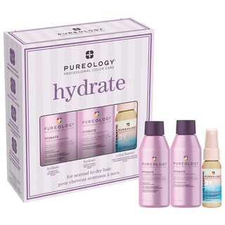 product set of mini shampoo, conditioner, and leave in spray. The shampoo and conditioner are in light purple bottles with a twist off cap in dark purple. The leave in spray is beige with a pink and blue label. The spray cap is a blush pink. Behind the products is the box it comes in which is light purple and has the products on the box.