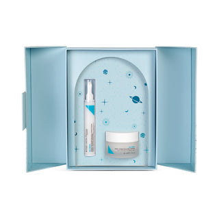 Light blue box open showcasing products , the eye cream in a tube and moisturizer in a frosted glass with a white lid