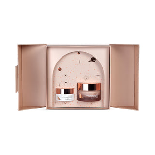 Skincare set with two jars in a decorative box on a white background