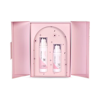 light pink box open showcasing products. Two white pump bottles with clear lids and pink label and black writing