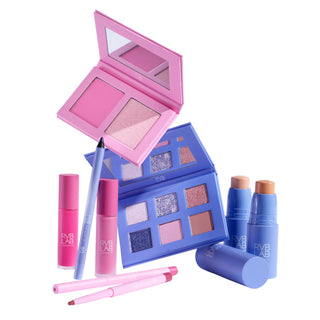 A collection of RVB LAB makeup products including a pink compact with two blush or highlighter shades, a blue eyeshadow palette with six shimmer and matte shades, two pink pip gloss tubes, two dual-ended eye or lip pencils in pink and mauve, and three BB Cream sticks in purple packaging labelled 'RVB LAB'.