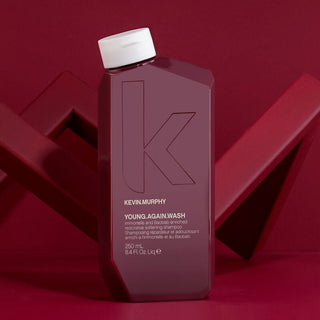 250ml bottle of Kevin Murphy Young Again Wash shampoo with a geometric red background.
