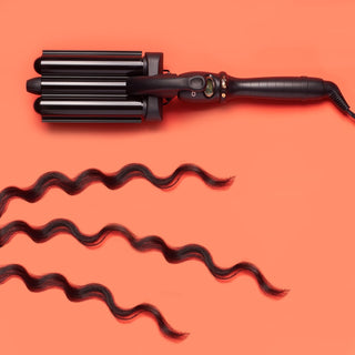 Amika High Tide Deep Waver hair tool with triple-barrel design for creating deep, beachy waves with hair pieces shown.